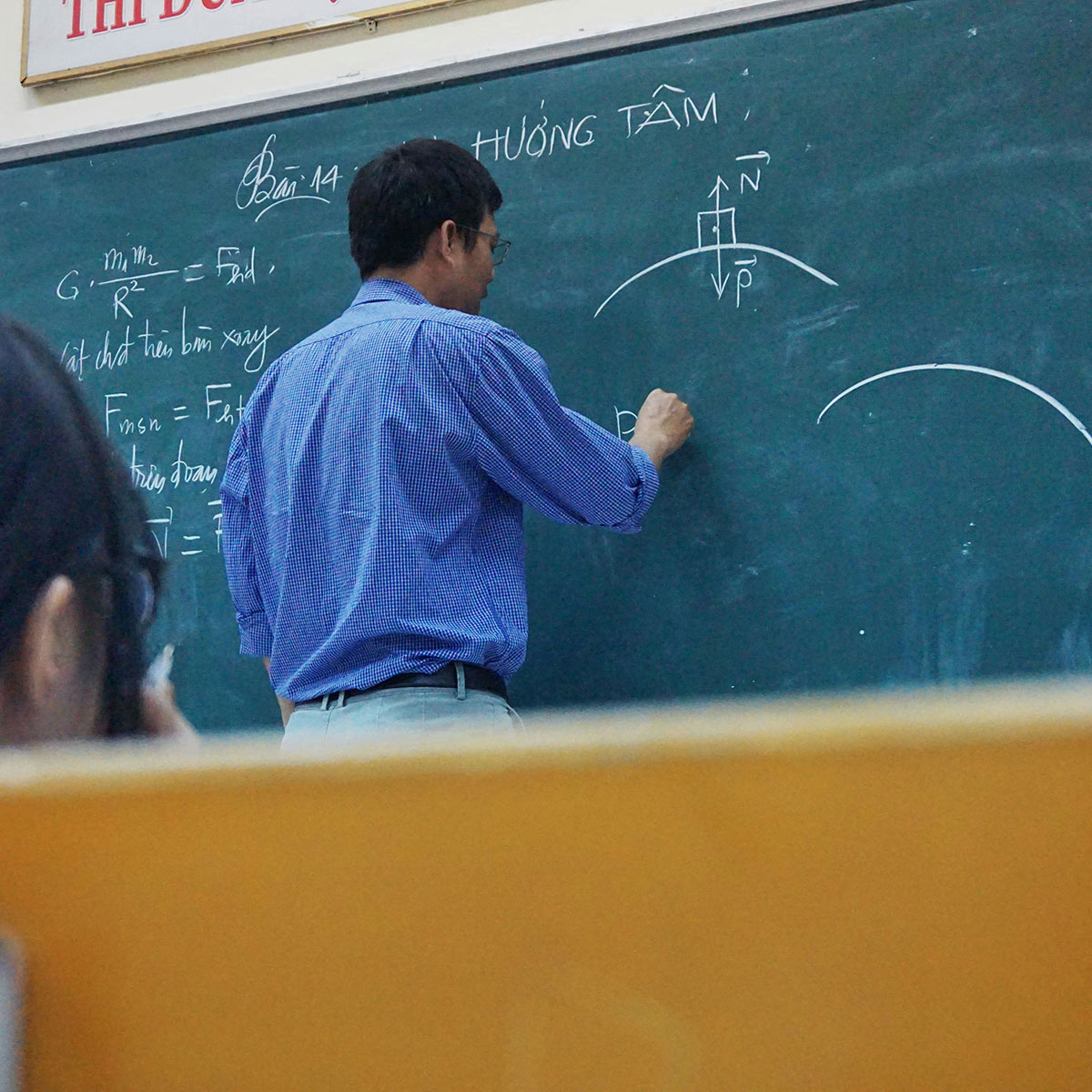 teacher at chalk board